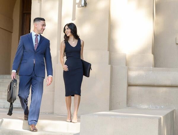 Two grad students on stairs of UCR Business Anderson Hall